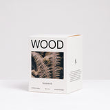 The branded box of an Wood-scented candle featuring an image of brown fern leaves, made by Homework and available at NiMi Projects UK.