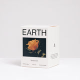 The branded box of an Earth-scented candle featuring an image of an orange rose, made by Homework and available at NiMi Projects UK.