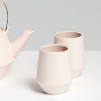 Two blush pink Japanese porcelain Frustum tea cups, made in Japan and available at NiMi Projects.