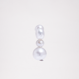 A front view of a Pokoko 5-pearl stud earring, made by Onomatopee, showcasing its three front freshwater pearls — a vertical arrangement of a medium, small and large pearl. Available at NiMi Projects UK.