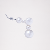 A side view of a Pokoko 5-pearl stud earring, made by Onomatopee, featuring a small freshwater pearl, tiny pearl and another large pearl at the top of the earring, and two more pearls dropping below them. Post is silver. Available at NiMi Projects UK. 