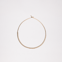 A gold vermeil, small Onomatopee Puchipuchi Hoop Earring, featuring a row of tiny dots along the bottom section of the hoop and 3 cm in diameter. Available at NiMi Projects UK.