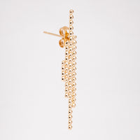 A side view of an Onomatopee Sasasa 4-stick stud earring in gold vermeil, showing its four lines of dots (from left to right: 4--11-23-14) and the earring's butterfly.  Available at NiMi Projects UK.