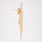 A side view of an Onomatopee Sasasa 4-stick stud earring in gold vermeil, showing its four lines of dots (from left to right: 4--11-23-14) and the earring's butterfly.  Available at NiMi Projects UK.