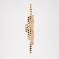 A top view of an Onomatopee Sasasa 4-stick stud earring in gold vermeil, featuring four lines of different lengths of dots. Number of dots from left to right: 4--11-23-14. Available at NiMi Projects UK.