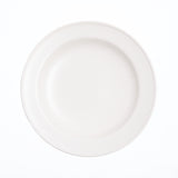 Top view of a creamy white, round Kihon no Utsuwa Japanese porcelain, rimmed side dish, with lightly curved base. Available at NiMi Projects UK.