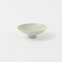 A Kihon no Utsuwa porcelain rice bowl or side dish in duck-egg blue, featuring a small platform base. Made in Japan and available at NiMi Projects UK.