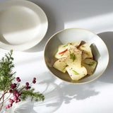 A serving of apple salad in a duck-egg blue Kihon no Utsuwa Japanese porcelain rice-bowl shaped dish.