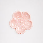 An ariel view of a pink sakura (cherry blossom) Japanese, Mino-yaki ceramic hashioki chopstick rest. Available at NiMi Projects.