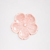 An ariel view of a pink sakura (cherry blossom) Japanese, Mino-yaki ceramic hashioki chopstick rest. Available at NiMi Projects.