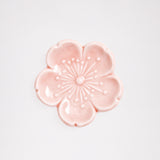 An ariel view of a pink sakura (cherry blossom) Japanese, Mino-yaki ceramic hashioki chopstick rest. Available at NiMi Projects.