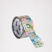 A roll of pastel coloured Bande Japanese washi paper house shaped stickers. Each house is different in design individually cut  and layered on top of the one before to create the row of stickers. Available at NiMi Projects UK.