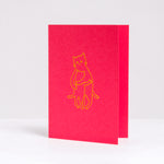 Designed and letter-press printed by Takako Copeland, the Kitty Hug card is red and features an illustration in yellow of a parent cat giving a kitten a warm all-embracing hug.