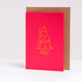 Designed and letter-press printed by Takako Copeland, the Kitty Hug card features parent cat giving a kitten a warm all-embracing hug. A simple yellow line drawing against a vibrant red background that expresses so much.