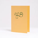  Letterpress printed in green on bright yellow, Takako Copeland's Oxalis Card features an illustration of a bundle of Oxalis growing tall as they are watered by a long-spout watering can.