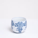 A vintage porcelain Japanese teacup in white with a delicate pattern of a bamboo forest. Available at NiMi Projects. 