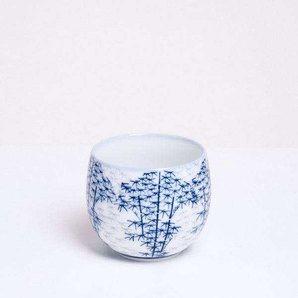 A vintage porcelain Japanese teacup in white with a delicate pattern of a bamboo forest. Available at NiMi Projects. 