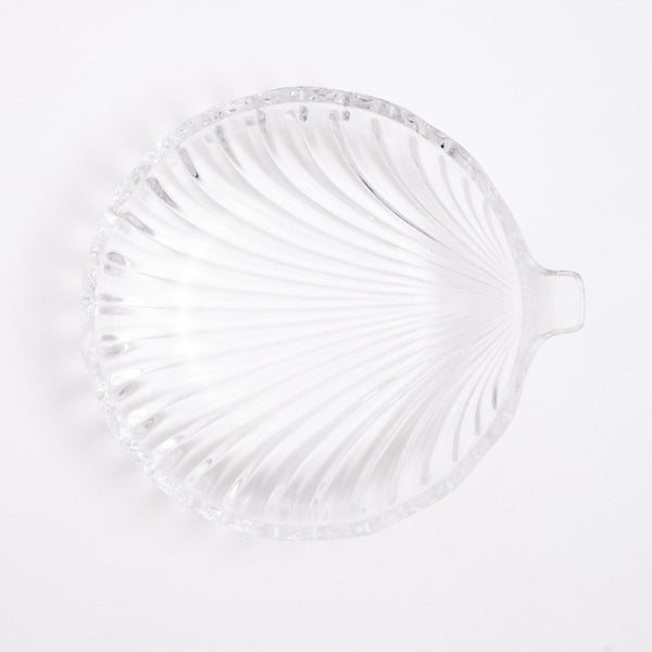 Top view of a heavy, vintage Japanese glass shell-shaped bowl, showing the arched lines of the shell shape from beneath and circular form. On show at NiMi Projects UK