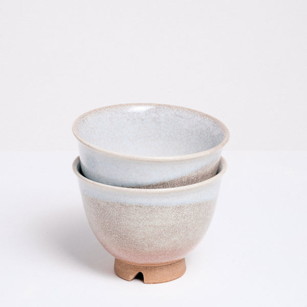 Two stacked vintage Hagi-yaki (rustic style) Japanese ceramic teacups, featuring an orange clay base, crackle glaze and decorative drip white glaze. Available at NiMi Projects UK.