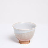 A vintage Hagi-yaki (rustic style) Japanese ceramic teacup, showcasing an orange clay base, crackle glaze and decorative drip white glaze. On show at NiMi Projects UK.