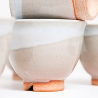 A closeup of the base of a Hagi-yaki, rustic-style ceramic Japanese teacup, showing its signature kiri-koudai triangular notch. Available at NiMI Projects UK.