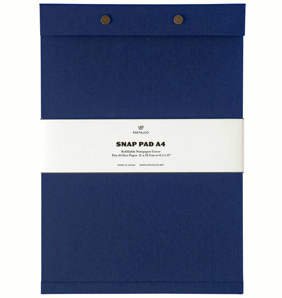 A French blue fabric-covered A4 Postalco Snap Pad, showing the two roundmetal snap clasps at its top and a white label wrapped around its center featuring the Postalco bird logo.