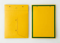 An top view of two Postalco Snap Pocket envelopes in mustard yellow, featuring holes at the top to attach to a Snap Pad. One side is lined and features the Postalco bird logo at the top, the other side is plain yellow with a dark green border.