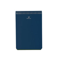 A top image of a Postalco A6 Note Book in French blue, with a spiral top and featuring the Postalco bird logo debossed in gold.