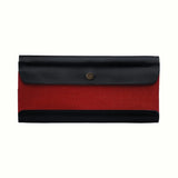 A Postalco Tool Box pen case, showcasing a navy blue, soft, cowhide leather top with metal snap clasp and a central panel of red cotton canvas.
