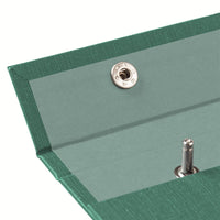 A detail image of the top left of a dark green pressed cotton covered Postalco Snap Pad, showing a dark green interior textile and an open metal snap clasp.