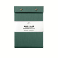 A dark green pressed-cotton covered Postalco Snap Pad, showing the two roundmetal snap clasps at its top and a white label wrapped around its center featuring the Postalco bird logo.