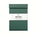 A dark green pressed-cotton covered Postalco Snap Pad, showing the two roundmetal snap clasps at its top and a white label wrapped around its center featuring the Postalco bird logo.