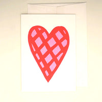 A white Takako Copeland illustrated Valentines card, featuring a giant pink heart patterned with a red check.  Available at NiMi Projects.